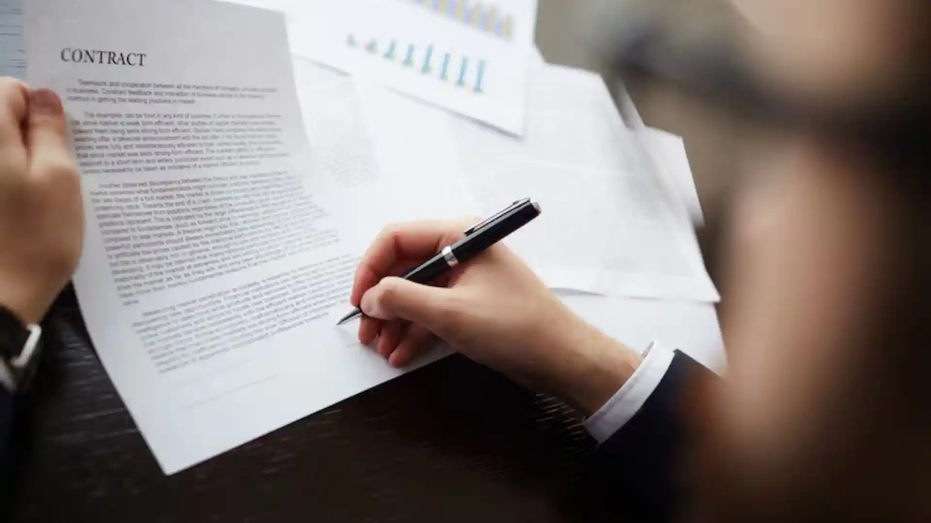 Image: reviewing a contract at a desk